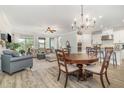 Open concept living space featuring hardwood floors, a comfortable seating area, and modern kitchen at 2342 Clemblue Rd, Clermont, FL 34715
