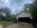 Attached two-car garage exhibiting ample storage space with driveway and partial front yard at 2435 Sweetwater Country Club Dr, Apopka, FL 32712