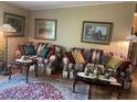Comfortable living room featuring floral sofas and decorative accents at 2808 Manatee Rd, Tavares, FL 32778
