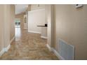 Neutral hallway featuring tile flooring connecting the home's living spaces at 2830 Alton Dr, Kissimmee, FL 34741