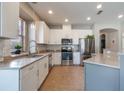 Modern kitchen featuring stainless steel appliances, white cabinetry, tile backsplash, and countertops at 3223 Blazing Star Ln, Harmony, FL 34773