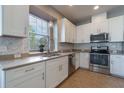Well-lit kitchen featuring stainless steel appliances, granite counters, undermount sink, and ample cabinet space at 3223 Blazing Star Ln, Harmony, FL 34773