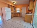 Well-lit kitchen with light wood cabinets and a white refrigerator at 3516 Ridgemont Rd, Orlando, FL 32808