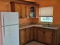 Kitchen with wood cabinets, stainless steel sink, and ample counter space at 3516 Ridgemont Rd, Orlando, FL 32808