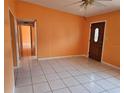 Spacious living room with tile floors and a ceiling fan at 3516 Ridgemont Rd, Orlando, FL 32808