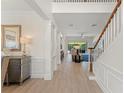 Welcoming hallway with staircase and elegant decor leading to the living room at 390 Anessa Rose Loop, Ocoee, FL 34761