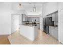 Modern kitchen features gray cabinets, granite countertops, stainless steel appliances, and an island at 4102 Boca Woods Dr, Orlando, FL 32826