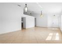 Bright living room featuring neutral paint, tile flooring, and pendant lighting at 4102 Boca Woods Dr, Orlando, FL 32826
