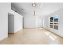 Bright living room featuring neutral paint, tile flooring, and ample natural light from a large window at 4102 Boca Woods Dr, Orlando, FL 32826