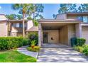 Inviting townhome with a convenient covered carport and lush landscaping enhancing its curb appeal at 458 Meadowood Blvd, Fern Park, FL 32730