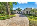 Home exterior view from the street shows circular paver driveway and elegant landscaping at 5157 Latrobe Dr, Windermere, FL 34786