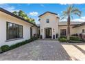 Beautiful front entrance with double doors, manicured landscaping and spacious paver drive at 5157 Latrobe Dr, Windermere, FL 34786