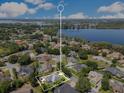 Gorgeous aerial view of the property showcasing its location and surrounding community with a large lake at 5335 Bay Side Dr, Orlando, FL 32819