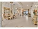 Elegant dining room with ornate details, stylish furniture, and a clear view of the outdoors at 5944 Lake Melrose Dr, Orlando, FL 32829