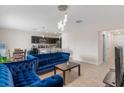 Bright living space with modern furnishings including two blue couches and open access to the kitchen at 601 Watusi Way, St Cloud, FL 34772