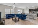 This spacious living room has tile flooring, modern lighting, and opens to the kitchen with breakfast bar at 601 Watusi Way, St Cloud, FL 34772