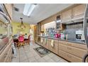 Well-lit kitchen with wooden cabinetry, granite countertops, and tile flooring, offering style and functionality at 604 Ponca Trl, Maitland, FL 32751