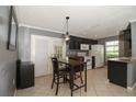 Cozy kitchen area with dark cabinets, tile flooring, and access to outdoor space through sliding doors at 610 Heatherton Vlg # 610, Altamonte Springs, FL 32714