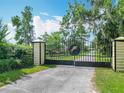 Wrought-iron driveway gate entrance to horse farm at 750 Sw 91St Pl, Ocala, FL 34476