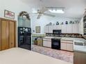 Bright kitchen featuring appliances, cabinetry, and tiled floor at 750 Sw 91St Pl, Ocala, FL 34476