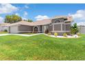 Well-manicured front yard with green grass and decorative landscaping, highlighting the home's curb appeal at 801 Hunt Dr, Lake Wales, FL 33853