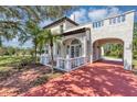 Charming home featuring a red tile roof, stucco walls, arched entry and brick driveway at 802 S 10Th St, Haines City, FL 33844
