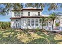 Elegant stucco home featuring arched windows, a red tile roof, and a well-manicured lawn at 802 S 10Th St, Haines City, FL 33844