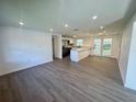 Open-concept living room flows into a modern kitchen, featuring sleek flooring and natural light at 804 Starke Lake Cir, Ocoee, FL 34761