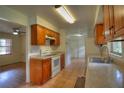 Traditional kitchen featuring tile floors, wooden cabinetry, and white appliances at 916 Great Bend Rd, Altamonte Springs, FL 32714