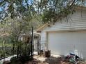 A detached garage exterior with overgrown foliage at 9325 Echo Run, Orlando, FL 32817
