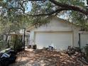 A detached garage exterior showing recent renovations and a two car garage at 9325 Echo Run, Orlando, FL 32817