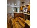 Kitchen area with stainless steel appliances, wood floors, and stone tile backsplash at 104 Oaks Ct, Sanford, FL 32771
