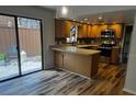 A kitchen with wooden cabinets, stainless steel appliances, and a breakfast bar at 104 Oaks Ct, Sanford, FL 32771