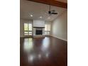 Bright living room with a fireplace, ceiling fan and large windows at 104 Oaks Ct, Sanford, FL 32771