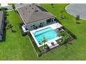 Aerial view of backyard featuring a private pool, patio furniture, and manicured lawn at 1313 Middle Lake Dr, Ormond Beach, FL 32174