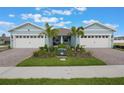 Charming home exterior with two car garages, lush landscaping and brick paver driveway at 13562 Pearl Beach St, Winter Garden, FL 34787