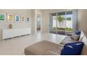 Bright living room with marble floors, a comfortable couch, and sliding door leading to the backyard at 13562 Pearl Beach St, Winter Garden, FL 34787