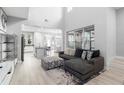 Bright, open-concept living room with soaring ceilings, large windows, and stylish contemporary decor at 14126 Walcott Ave, Orlando, FL 32827