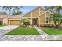 Charming single-Gathering home with a well-manicured lawn, beautiful landscaping, and a two-car garage at 14312 Paradise Tree Dr, Orlando, FL 32828