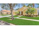 Lovely single-Gathering home featuring a well-manicured lawn, mature trees, and a spacious driveway at 14312 Paradise Tree Dr, Orlando, FL 32828