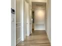 Hallway with modern wood floors and white doors at 148 Hampton Loop, Davenport, FL 33837