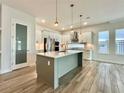 Bright kitchen featuring a center island with pendant lighting and stainless steel appliances at 148 Hampton Loop, Davenport, FL 33837