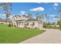 Well-maintained home featuring an attached garage and manicured lawn at 17657 Windy Pine St, Montverde, FL 34756
