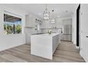 Bright kitchen with a large island, stainless steel appliances, and a view of the backyard at 17657 Windy Pine St, Montverde, FL 34756