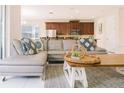Open living area with a gray sectional sofa, decorative pillows and stylish decor at 1836 Sandy Park Trl, Kissimmee, FL 34747