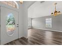 Bright living room with laminate flooring, decorative front door and arched doorway entrance at 2085 Friar Tuck Ln, Orange City, FL 32763