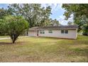 Charming single-story home with a well-manicured lawn and mature trees at 2311 Olivet Ave, Leesburg, FL 34748