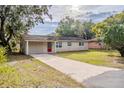Charming single-story home with a long driveway and mature trees at 2311 Olivet Ave, Leesburg, FL 34748