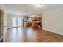 Open-concept kitchen and dining area featuring stainless steel appliances and a center island at 2311 Olivet Ave, Leesburg, FL 34748