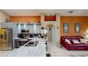 Modern kitchen featuring a breakfast bar, stainless steel appliances, and ample counter space at 2506 Shelby Cir, Kissimmee, FL 34743